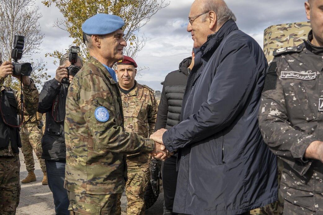 Commander Lieutenant General Aroldo Lázaro shakes hands with Lebanese Prime Minister Najib Miqati.